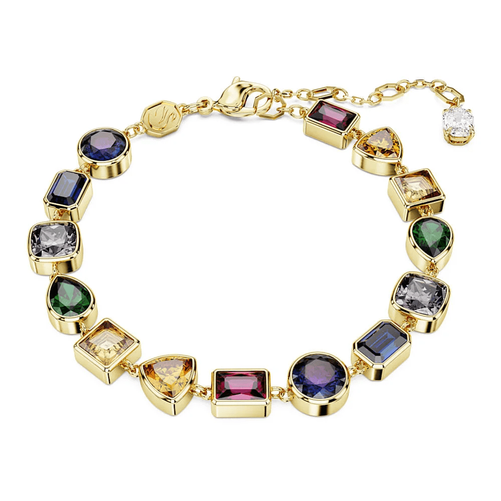 Pulsera de lujo adornada con una variedad de piedras preciosas de diferentes formas y colores, todas engarzadas en una base de oro.